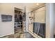 Bathroom featuring a glass shower and access to a walk-in closet for added convenience at 11769 Lovegrass Dr, Parker, CO 80138