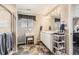 Well-lit bathroom with double sinks, a makeup vanity, and a tiled shower at 11769 Lovegrass Dr, Parker, CO 80138