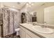 Bathroom with double sinks, shower and tub combo, and a large mirror at 11769 Lovegrass Dr, Parker, CO 80138
