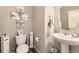 Charming powder room featuring modern fixtures, neutral paint, and stylish decor at 11769 Lovegrass Dr, Parker, CO 80138