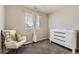 Comfortable Bedroom featuring a rocking chair, dresser, and soft neutral tones at 11769 Lovegrass Dr, Parker, CO 80138