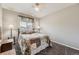 Cozy bedroom with a full-size bed, complemented by soft carpeting and a ceiling fan at 11769 Lovegrass Dr, Parker, CO 80138
