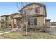 Beautiful two-story home boasts stone accents, a well-maintained lawn, and covered porch at 11769 Lovegrass Dr, Parker, CO 80138