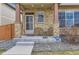 Inviting front porch with stone pillars, outdoor seating, and security system at 11769 Lovegrass Dr, Parker, CO 80138
