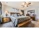 Comfortable bedroom with coordinated decor, a ceiling fan, and warm lighting at 11769 Lovegrass Dr, Parker, CO 80138