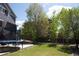 Well-manicured backyard with mature trees and a concrete patio, perfect for outdoor entertaining at 3725 S Nepal St, Aurora, CO 80013