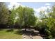 Backyard featuring mature trees and landscaping, creating a tranquil and inviting outdoor setting at 3725 S Nepal St, Aurora, CO 80013