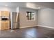 Finished basement with a kitchenette, stainless steel refrigerator and natural light from window at 3725 S Nepal St, Aurora, CO 80013