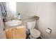 Updated bathroom vanity with sink, lighting, and modern toilet at 3725 S Nepal St, Aurora, CO 80013