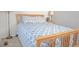Cozy bedroom features natural wood furniture and soft blue patterned bedding at 3725 S Nepal St, Aurora, CO 80013