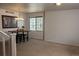 Open dining area with modern light fixture and barstools with a nearby staircase at 3725 S Nepal St, Aurora, CO 80013