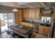 Bright kitchen with stainless steel appliances, center island, and light wood cabinets at 3725 S Nepal St, Aurora, CO 80013
