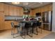 Updated kitchen with granite countertops, stainless appliances, island with bar seating and light wood cabinets at 3725 S Nepal St, Aurora, CO 80013