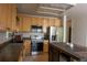 Updated kitchen with granite countertops, stainless appliances and light wood cabinetry at 3725 S Nepal St, Aurora, CO 80013