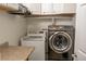 Functional laundry room with a front load washer and dryer at 3725 S Nepal St, Aurora, CO 80013