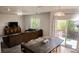Open living room with a large sectional sofa and entertainment center; eat in kitchen is visible at 3725 S Nepal St, Aurora, CO 80013