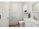 A full bathroom with white fixtures, storage cabinet, and tiled flooring at 1324 State Highway 66, Longmont, CO 80504