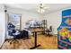 Functional bedroom setup with a desk, multiple monitors, an arcade game and a comfortable gaming chair, ideal for work and play at 1324 State Highway 66, Longmont, CO 80504
