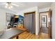 Versatile bedroom showcasing an arcade game, a spacious desk, and an access to a closet and another room, offering flexibility at 1324 State Highway 66, Longmont, CO 80504