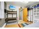 Functional bedroom setup with a work area, TV and direct access to the bathroom and closet, ideal for relaxation and convenience at 1324 State Highway 66, Longmont, CO 80504