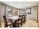 Bright dining room featuring neutral walls, tile floors, and backyard views through large windows at 1324 State Highway 66, Longmont, CO 80504