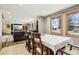 Dining area with tile floors and large windows that seamlessly connects to the cozy living room at 1324 State Highway 66, Longmont, CO 80504