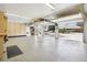 Expansive garage with epoxy floors, built-in storage, and open doors to the driveway at 1324 State Highway 66, Longmont, CO 80504
