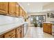 Traditional-style kitchen with wooden cabinets, a stainless steel sink and outdoor views at 1324 State Highway 66, Longmont, CO 80504