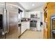 Bright kitchen featuring stainless steel appliances, white cabinets, and granite countertops at 1324 State Highway 66, Longmont, CO 80504