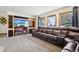 Media room with built-ins, large screen TV and plush leather sofa for cozy relaxation at 1324 State Highway 66, Longmont, CO 80504