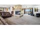 Spacious living room boasting a stone fireplace, neutral carpeting, and backyard access at 1324 State Highway 66, Longmont, CO 80504