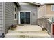 Back patio with flowers, steps and sliding door entrance to house at 3548 Swabuck Pl, Castle Rock, CO 80109