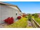 Large grassy backyard featuring a wooden fence, red bushes, and view of the neighborhood at 3548 Swabuck Pl, Castle Rock, CO 80109