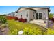 Landscaped backyard with red bushes, green grass, and a patio at 3548 Swabuck Pl, Castle Rock, CO 80109