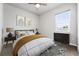 Bright bedroom featuring a large window, ceiling fan, stylish furnishings, and neutral decor at 3548 Swabuck Pl, Castle Rock, CO 80109
