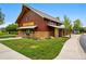 Exterior of a community building with stone base, brown siding and attractive landscaping at 3548 Swabuck Pl, Castle Rock, CO 80109