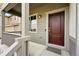 Inviting front entry with a dark wood door, a stylish light fixture, and well-kept porch at 3548 Swabuck Pl, Castle Rock, CO 80109
