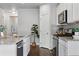 Modern kitchen with white cabinets, stainless steel appliances, and a functional layout at 3548 Swabuck Pl, Castle Rock, CO 80109