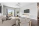 Bright living room featuring a neutral sofa, a ceiling fan, and a sliding glass door to the outside at 3548 Swabuck Pl, Castle Rock, CO 80109