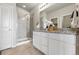 Stylish main bathroom with double vanity, granite countertops, and a glass-enclosed shower at 3548 Swabuck Pl, Castle Rock, CO 80109