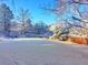 A serene backyard covered in fresh snow showcasing the property's landscape and fencing at 6918 E Easter Pl, Centennial, CO 80112