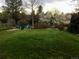 Expansive backyard featuring a manicured lawn, landscaping, and inviting Adirondack chairs at 6918 E Easter Pl, Centennial, CO 80112
