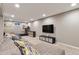 A spacious basement featuring a large sectional sofa, television, and fitness equipment at 6918 E Easter Pl, Centennial, CO 80112