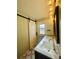 Charming bathroom with double sinks, sliding barn door, and modern light fixtures at 6918 E Easter Pl, Centennial, CO 80112