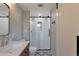 A modern bathroom with a tiled shower, updated vanity, and stylish flooring at 6918 E Easter Pl, Centennial, CO 80112
