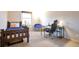 Well-lit bedroom with a wooden bed frame, study area, and a comfortable desk chair at 6918 E Easter Pl, Centennial, CO 80112