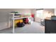 A bedroom features a loft bed, a cozy chair, and plenty of room to play at 6918 E Easter Pl, Centennial, CO 80112