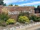 Homestead community entrance featuring a brick wall and beautiful landscaping with flowers and grasses at 6918 E Easter Pl, Centennial, CO 80112