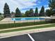 Large community pool surrounded by lush landscaping and a secure fence at 6918 E Easter Pl, Centennial, CO 80112