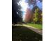 Scenic view of trees with fall foliage lining a paved path in the neighborhood at 6918 E Easter Pl, Centennial, CO 80112